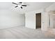 Spacious main bedroom with neutral carpet, ceiling fan, and ensuite bathroom with glass enclosed shower at 5527 Fairhaven Pl, Fairburn, GA 30213