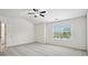Bright primary bedroom with ceiling fan and large window overlooking the yard at 5527 Fairhaven Pl, Fairburn, GA 30213