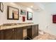 Bathroom with a double sink vanity featuring granite countertops and dark wood cabinets with tile flooring at 3777 Peachtree Ne Rd # 412, Brookhaven, GA 30319