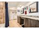 Bathroom featuring a double sink vanity, granite countertops, tile flooring, and a laundry area with washer and dryer at 3777 Peachtree Ne Rd # 412, Brookhaven, GA 30319