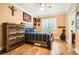 Cozy bedroom with wood floors, ceiling fan, wooden dresser, and shuttered windows at 3777 Peachtree Ne Rd # 412, Brookhaven, GA 30319