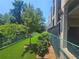 View of the community dog park surrounded by mature trees and building architecture at 3777 Peachtree Ne Rd # 412, Brookhaven, GA 30319