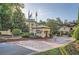 Elegant community entrance with flags and fountains surrounded by lush landscaping creating a refined atmosphere at 3777 Peachtree Ne Rd # 412, Brookhaven, GA 30319