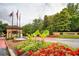 Welcoming entrance to Peachtree Place with fountain, colorful flower beds, and lush greenery at 3777 Peachtree Ne Rd # 412, Brookhaven, GA 30319