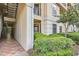 Exterior building corner with stairwell, lush landscaping, and patio area, offering a blend of accessibility and serene outdoor living at 3777 Peachtree Ne Rd # 412, Brookhaven, GA 30319