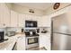 Bright kitchen with white cabinets, stainless steel appliances, and modern countertops at 3777 Peachtree Ne Rd # 412, Brookhaven, GA 30319