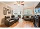 Cozy living room with modern recliners, hardwood floors, and ample natural light from large windows at 3777 Peachtree Ne Rd # 412, Brookhaven, GA 30319