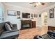 A stylish living room with modern furniture, fireplace, and ceiling fan with shuttered windows at 3777 Peachtree Ne Rd # 412, Brookhaven, GA 30319
