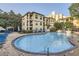A beautiful community pool surrounded by lounge chairs and landscaping by the condominiums at 3777 Peachtree Ne Rd # 412, Brookhaven, GA 30319