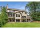 Expansive backyard featuring mature trees, a deck, screened porch, and a walk-out basement at 4823 Layfield Dr, Atlanta, GA 30338