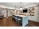 Basement kitchen boasts an island with seating, a TV, and custom shelves at 4823 Layfield Dr, Atlanta, GA 30338