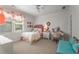 Cozy bedroom with a large window, ceiling fan, and vanity desk at 4823 Layfield Dr, Atlanta, GA 30338