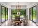 Dining room with hardwood floors, modern lighting, and backyard views at 4823 Layfield Dr, Atlanta, GA 30338