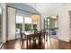 Cozy dining room with modern light fixture, elegant wallpaper, and view to the screened porch at 4823 Layfield Dr, Atlanta, GA 30338