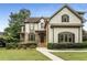 Charming two-story home featuring a combination of stone and siding with lush landscaping at 4823 Layfield Dr, Atlanta, GA 30338