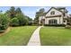 Expansive front lawn leading to a beautiful home, showcasing lush greenery and meticulous landscaping at 4823 Layfield Dr, Atlanta, GA 30338