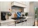 Modern kitchen with stainless steel range, white cabinetry, and herringbone backsplash at 4823 Layfield Dr, Atlanta, GA 30338