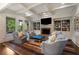 Bright living room features coffered ceilings, fireplace, built-in bookshelves, and four comfortable chairs at 4823 Layfield Dr, Atlanta, GA 30338