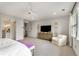 Bright main bedroom featuring neutral tones, ceiling fan, and sitting area at 4823 Layfield Dr, Atlanta, GA 30338