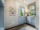 Functional mudroom with storage cabinets, butterfly art, and exterior access to the outdoors at 4823 Layfield Dr, Atlanta, GA 30338