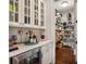 Walk-in pantry with ample shelving and storage, complemented by a beverage refrigerator in the foreground at 4823 Layfield Dr, Atlanta, GA 30338