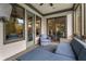 Inviting screened porch with plush seating, ceiling fan, and view into the dining room at 4823 Layfield Dr, Atlanta, GA 30338