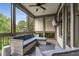 Relaxing screened porch with comfortable seating, ceiling fan, and wooded backyard views at 4823 Layfield Dr, Atlanta, GA 30338