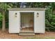 Charming backyard shed with hanging chair is a great place to enjoy peace and quiet at 4823 Layfield Dr, Atlanta, GA 30338