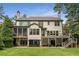 Large back exterior features a patio, screened in porch and large grassy yard at 4823 Layfield Dr, Dunwoody, GA 30338