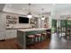 Finished basement bar area with marble countertop, pendant lighting and backyard view at 4823 Layfield Dr, Dunwoody, GA 30338