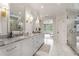 Luxurious bathroom with double vanity, marble countertops, and glass-enclosed shower at 4823 Layfield Dr, Dunwoody, GA 30338