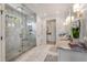 Luxurious bathroom features glass enclosed shower, marble tile, double vanity sinks and designer fixtures at 4823 Layfield Dr, Dunwoody, GA 30338