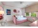 Charming bedroom featuring soft pink accents, a cozy daybed, and stylish decor, creating a welcoming and relaxing space at 4823 Layfield Dr, Dunwoody, GA 30338