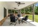 Inviting covered porch with comfortable seating, ceiling fans, and views of the backyard at 4823 Layfield Dr, Dunwoody, GA 30338