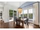 Dining room boasts modern chandelier, wallpaper, and access to the outdoor deck at 4823 Layfield Dr, Dunwoody, GA 30338