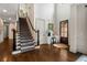 Grand foyer with hardwood flooring, staircase, and a dark wooden front door creating a warm welcome at 4823 Layfield Dr, Dunwoody, GA 30338