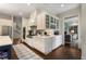 Bright kitchen features custom white cabinetry, stainless steel appliances and marble countertops at 4823 Layfield Dr, Dunwoody, GA 30338