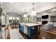 Open-concept kitchen featuring a center island with stool seating and seamlessly connects to the dining and living areas at 4823 Layfield Dr, Dunwoody, GA 30338