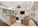Cozy living room boasts built-in shelving, a modern ceiling fan and comfortable seating around a round coffee table at 4823 Layfield Dr, Dunwoody, GA 30338