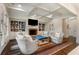 Inviting living room showcases fireplace, built-in bookshelves, and coffered ceilings at 4823 Layfield Dr, Dunwoody, GA 30338