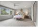 Bright main bedroom has large windows, a ceiling fan, and neutral decor at 4823 Layfield Dr, Dunwoody, GA 30338