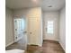 Bright entryway showcasing wood floors, white walls, and glass paneled doors at 670 Redhead Way (Lot 23), Grayson, GA 30017