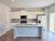 Modern kitchen with white cabinets, granite countertops, and stainless steel appliances at 670 Redhead Way (Lot 23), Grayson, GA 30017