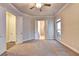 Spacious carpeted bedroom with neutral walls, a ceiling fan, and access to an ensuite bathroom at 520 Pearl St, Cumming, GA 30040