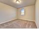 Bedroom with neutral carpeting, a window and a ceiling mounted light at 520 Pearl St, Cumming, GA 30040