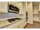 Well-equipped kitchen with stainless steel appliances, granite counters, and ample cabinet space at 520 Pearl St, Cumming, GA 30040