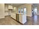 Modern kitchen featuring a central island, granite countertops, and stainless steel appliances at 520 Pearl St, Cumming, GA 30040