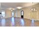 Expansive living room with hardwood floors, bright windows, and elegant lighting fixtures at 520 Pearl St, Cumming, GA 30040