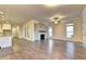 Open living area showcasing hardwood floors, a cozy fireplace, and ample natural light from surrounding windows at 520 Pearl St, Cumming, GA 30040