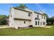 A two-story home with neutral siding and a large well-manicured green lawn in the backyard at 602 Jules Crest Ct, Lawrenceville, GA 30045